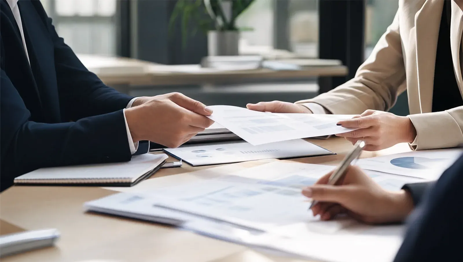 Reviewing business financials at a large table in a bright modern office